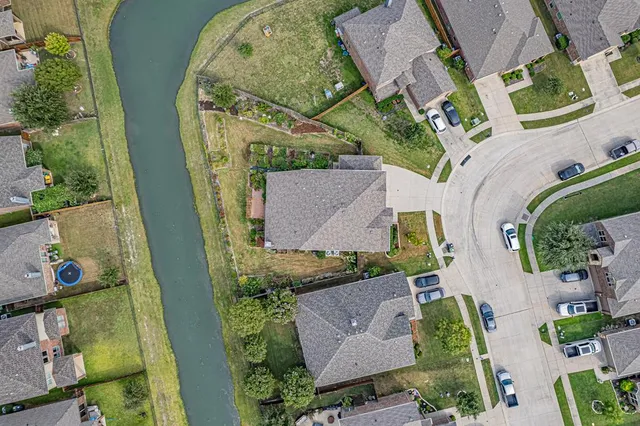 an aerial view of a house with a yard