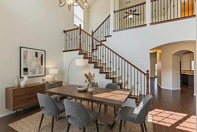 a dining room with furniture window and wooden floor