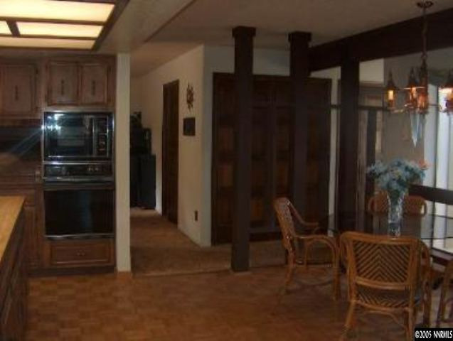 2771 East Lakeridge Reno, NV 89509 - Photo 6 of 8 a kitchen with a refrigerator and chairs