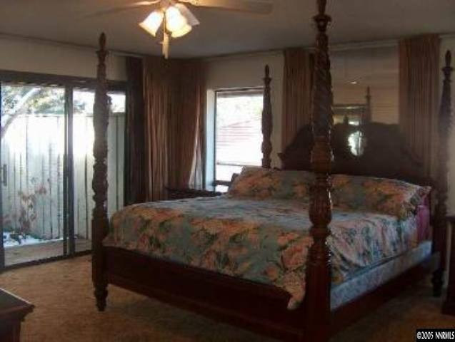 2771 East Lakeridge Reno, NV 89509 - Photo 8 of 8 a bedroom with a bed and a chandelier