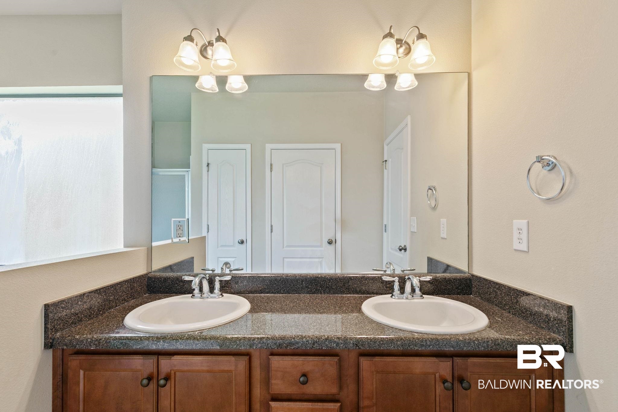 2216 Livingstone Court Mobile, AL 36695 - Photo 24 of 62 Double vanity featuring oval undermount sinks, chrome faucets, and a dark speckled countertop