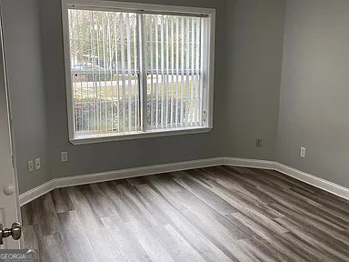 176 Whippoorwill Circle Kingsland, GA 31548 - Photo 11 of 18 a view of an empty room with wooden floor and a window