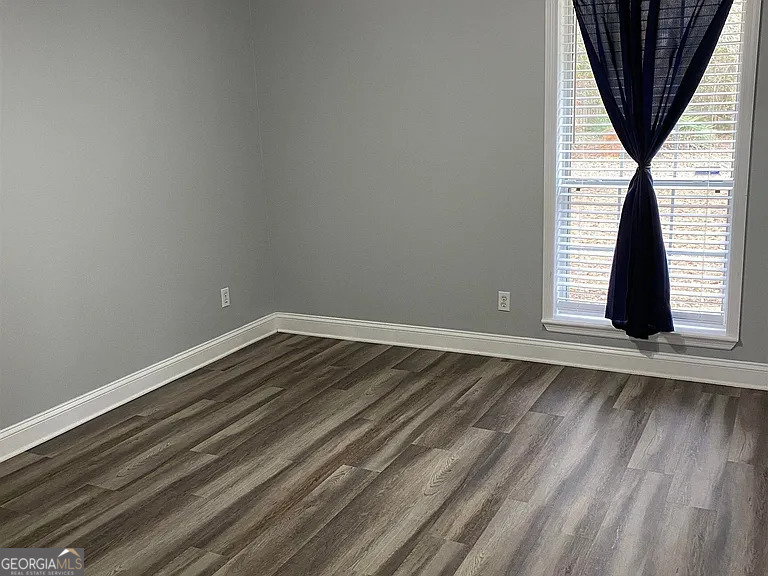 176 Whippoorwill Circle Kingsland, GA 31548 - Photo 12 of 18 a view of an empty room with wooden floor and a window