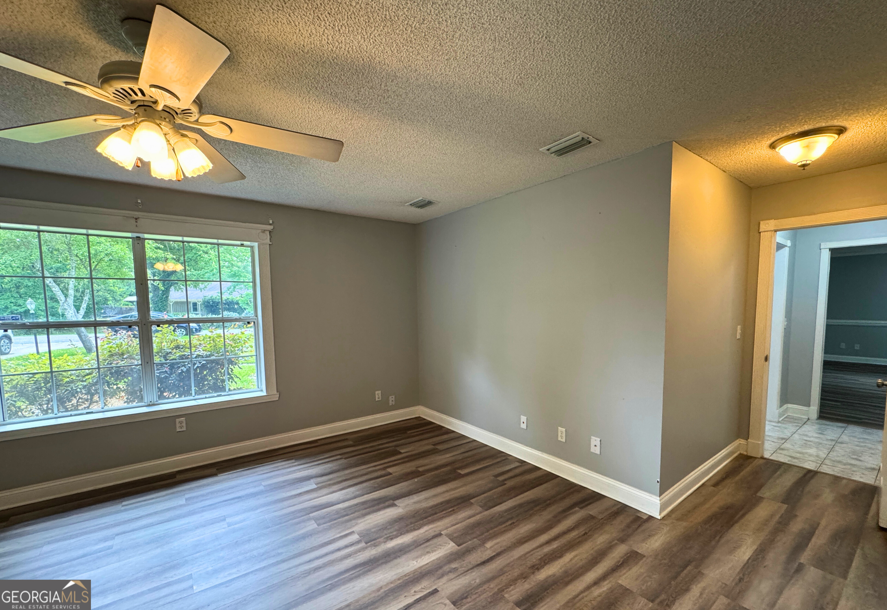 176 Whippoorwill Circle Kingsland, GA 31548 - Photo 14 of 18 an empty room with wooden floor fan and windows