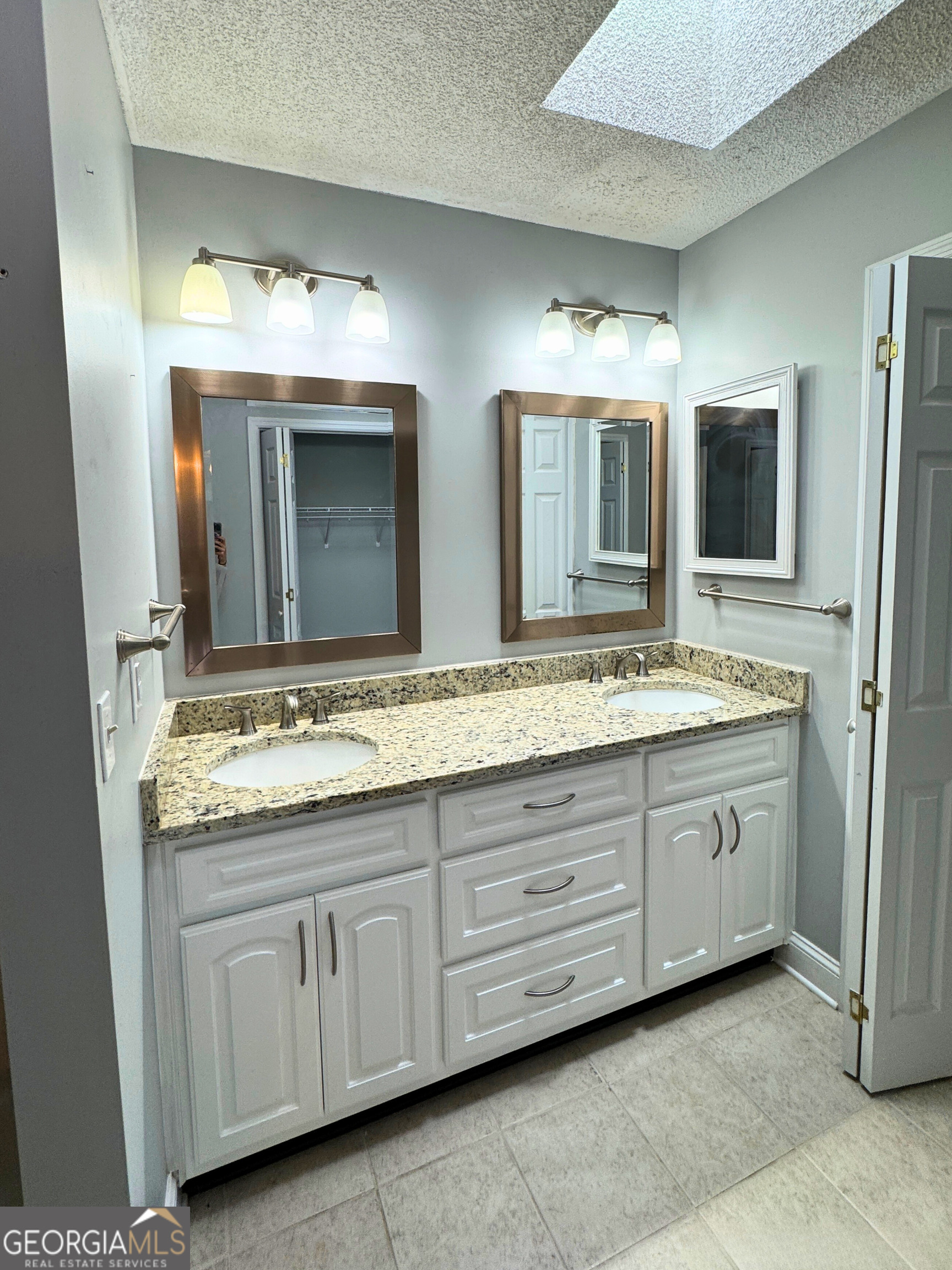 176 Whippoorwill Circle Kingsland, GA 31548 - Photo 15 of 18 a bathroom with a granite countertop sink double and mirror