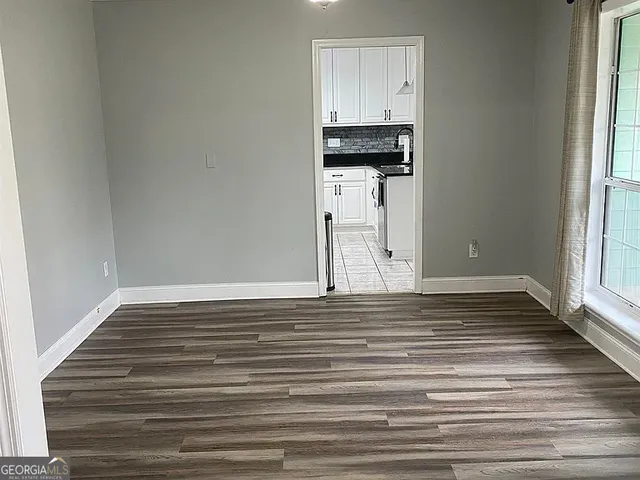 a view of a room with wooden floor and staircase