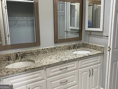 176 Whippoorwill Circle Kingsland, GA 31548 - Photo 10 of 18 a bathroom with a granite countertop sink and a mirror