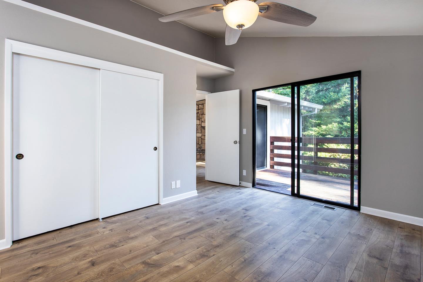 359 Moosehead Drive Aptos, CA 95003 - Photo 12 of 34 an empty room with wooden floor and windows