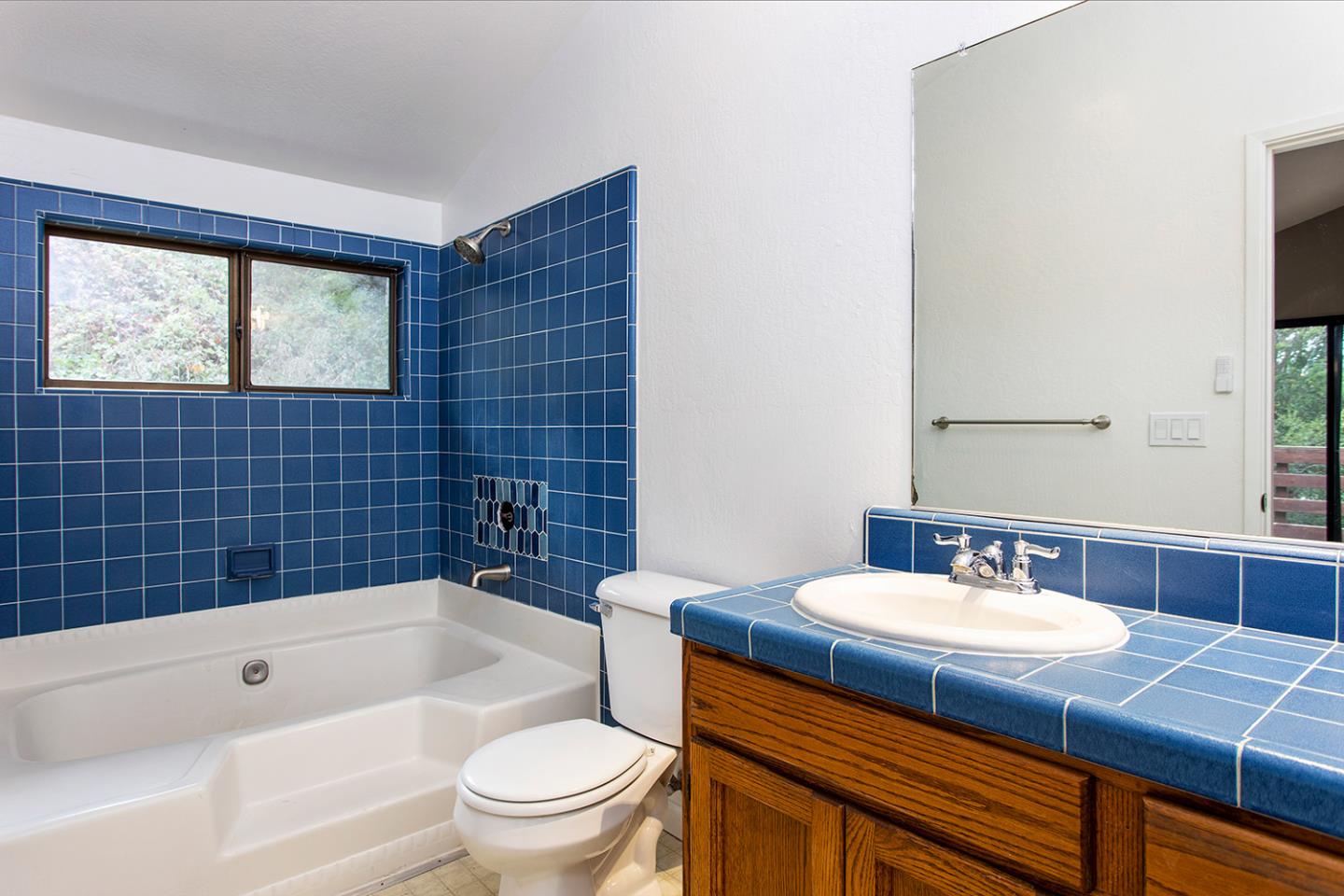 359 Moosehead Drive Aptos, CA 95003 - Photo 13 of 34 a bathroom with a sink a toilet a mirror a bathtub and shower