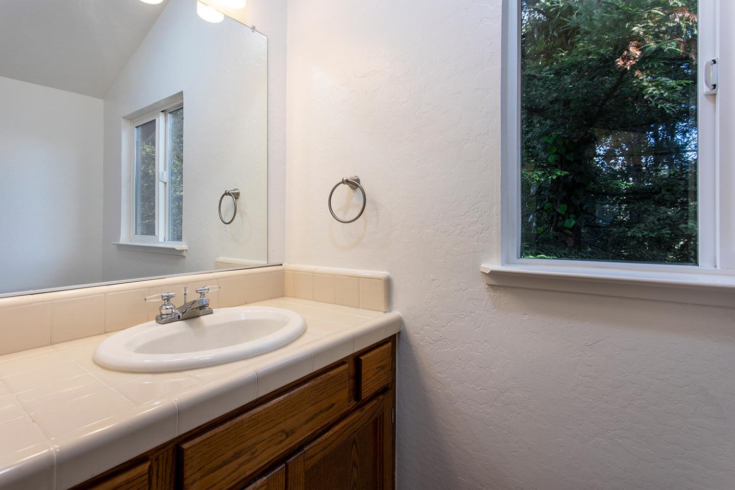 359 Moosehead Drive Aptos, CA 95003 - Photo 20 of 34 a bathroom with a sink and a mirror