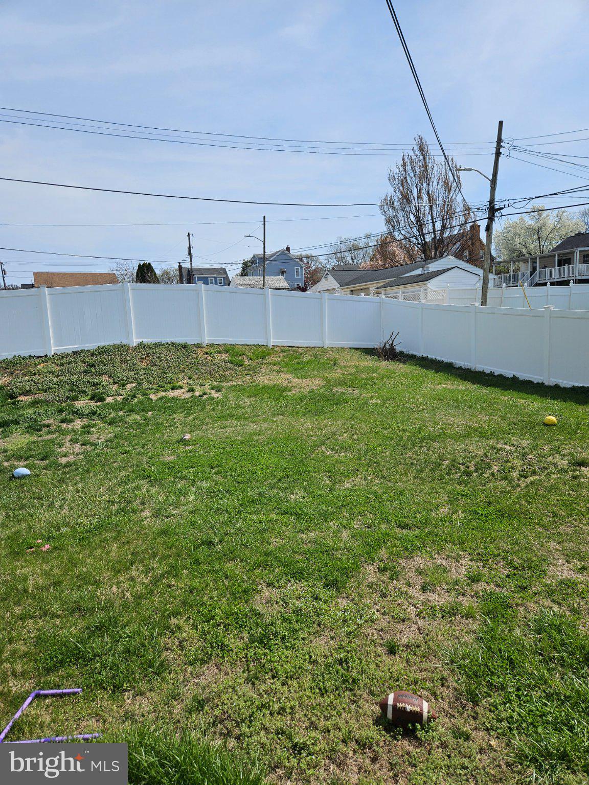 4005 3rd Street Baltimore, MD 21225 - Photo 3 of 7 Spacious green yard with a white fence.