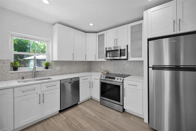 a room with a bed a television and a window