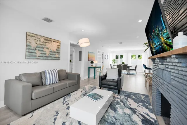 a kitchen with stainless steel appliances kitchen island granite countertop a refrigerator and a stove top oven