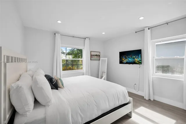 a open white kitchen with center island and living room