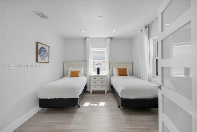 a kitchen with white cabinets and sink