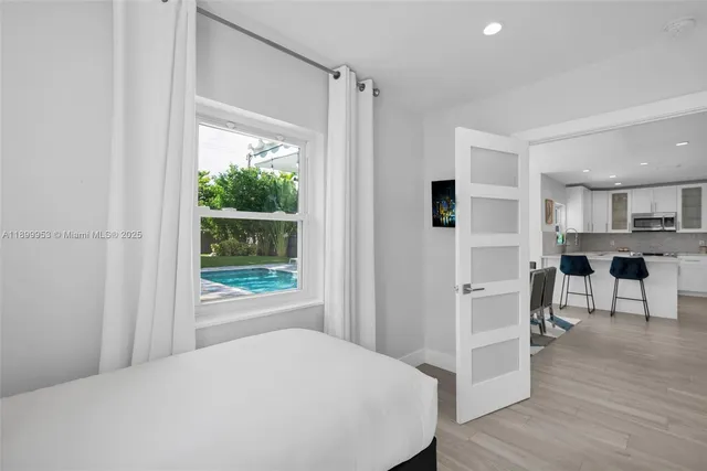 a view of backyard with swimming pool and outdoor seating