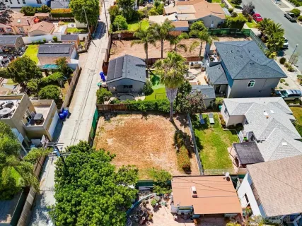 an aerial view of a house with a yard and lake view