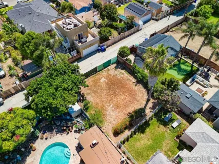 an aerial view of a house with a yard and potted plants
