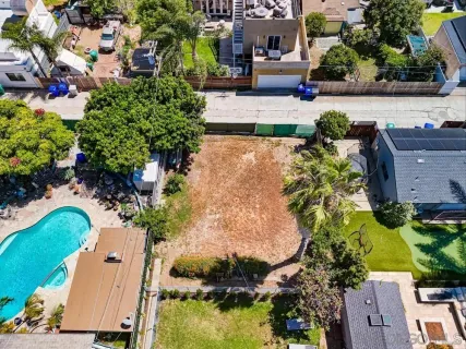 an aerial view of a house with a yard and lake view