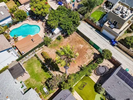 an aerial view of a house with a garden and swimming pool