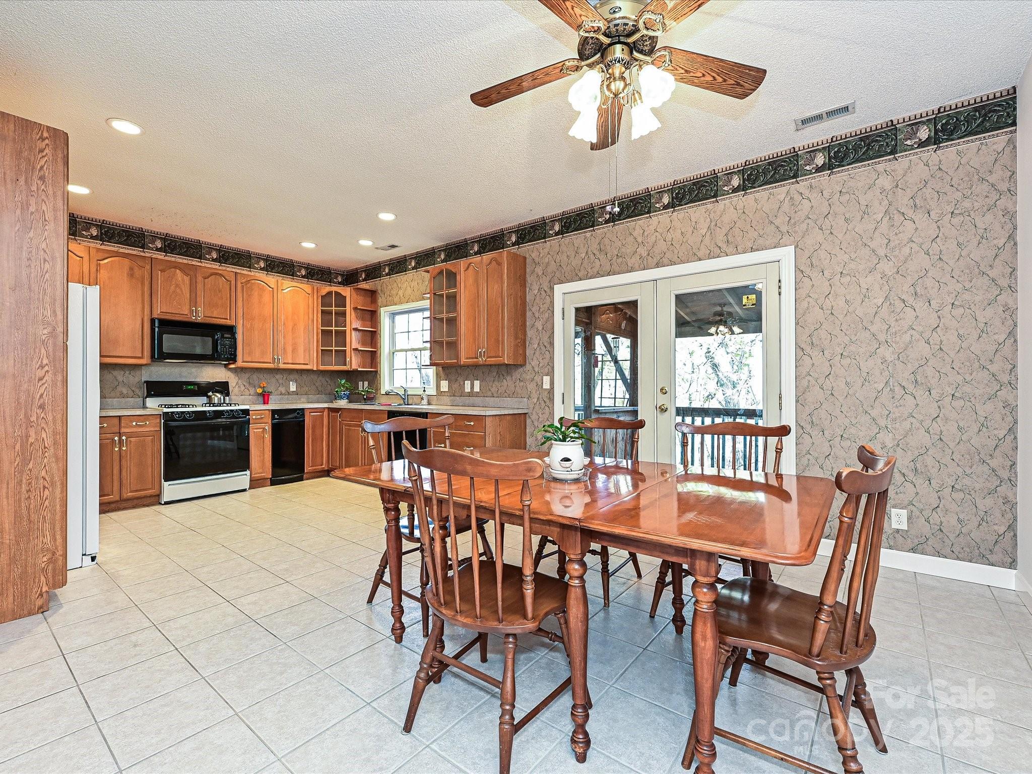 25040 Timberlake Drive Tega Cay, SC 29708 - Photo 10 of 40 a view of a dining room with furniture and a chandelier