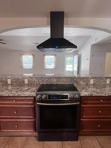 a stove top oven sitting inside of a kitchen counter top