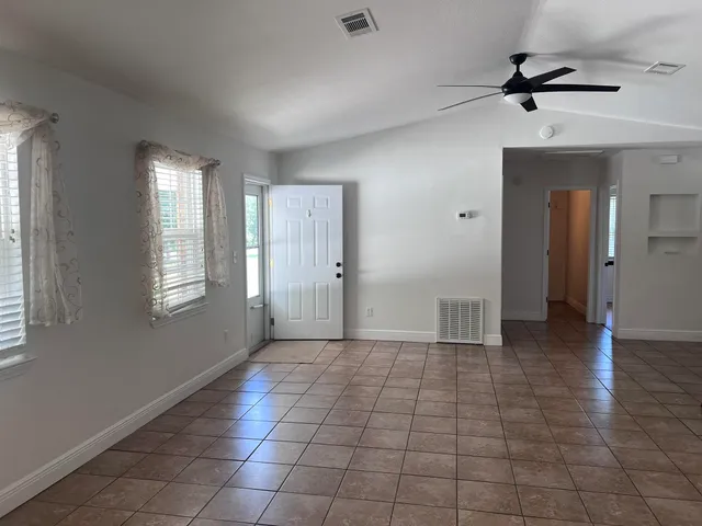 a view of a livingroom with a ceiling fan and window