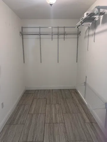 a view of a room with wooden floor