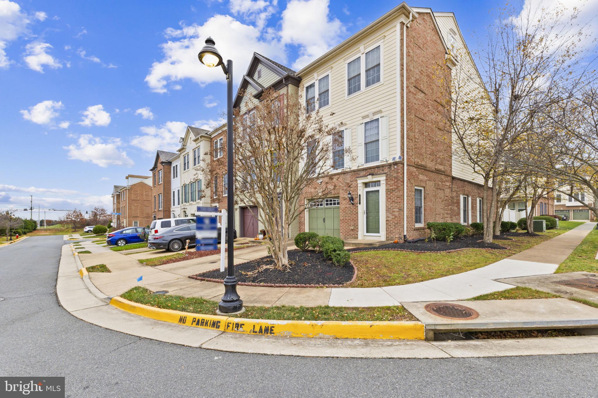573 Dandelion Terrace Southeast Leesburg, VA 20175 - Photo 1 of 31 a view of a white building with a fountain in front of a house