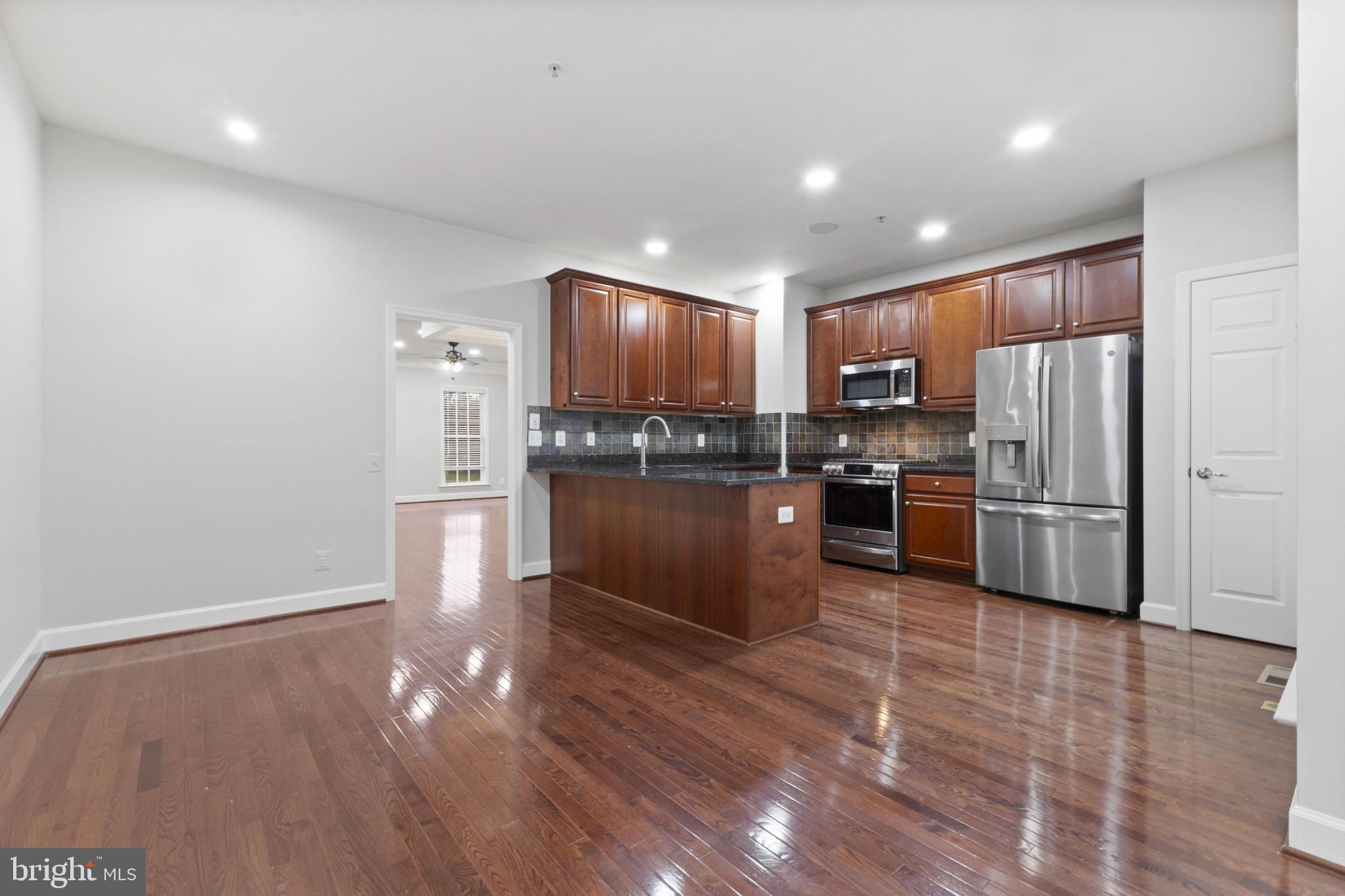 573 Dandelion Terrace Southeast Leesburg, VA 20175 - Photo 11 of 31 a kitchen with stainless steel appliances granite countertop a refrigerator and a stove top oven