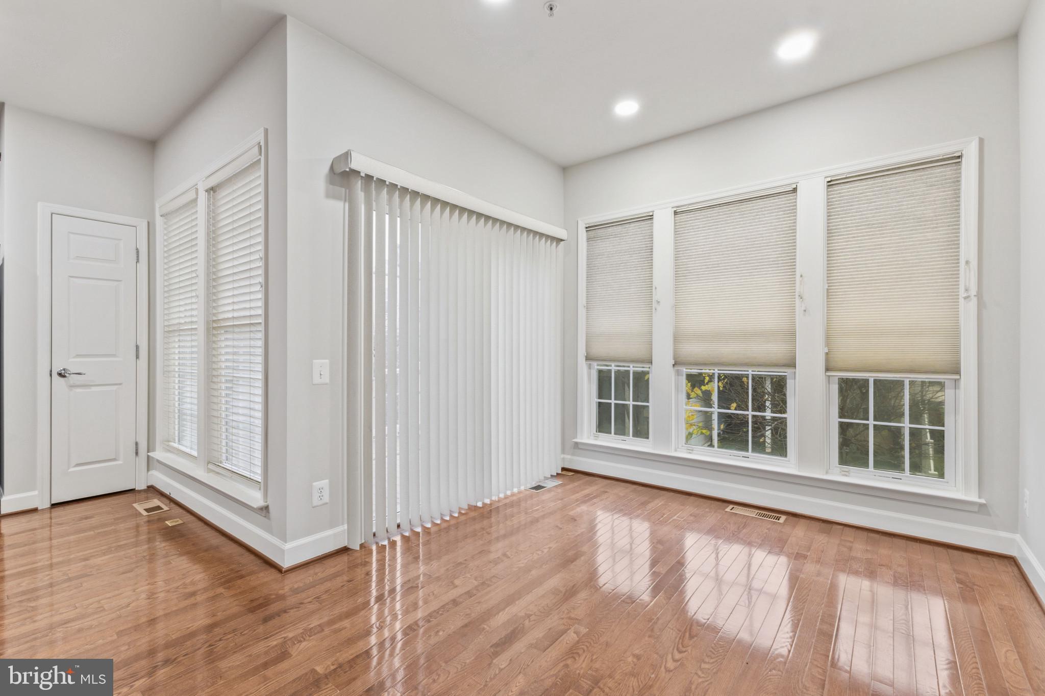 573 Dandelion Terrace Southeast Leesburg, VA 20175 - Photo 13 of 31 an empty room with wooden floor and windows
