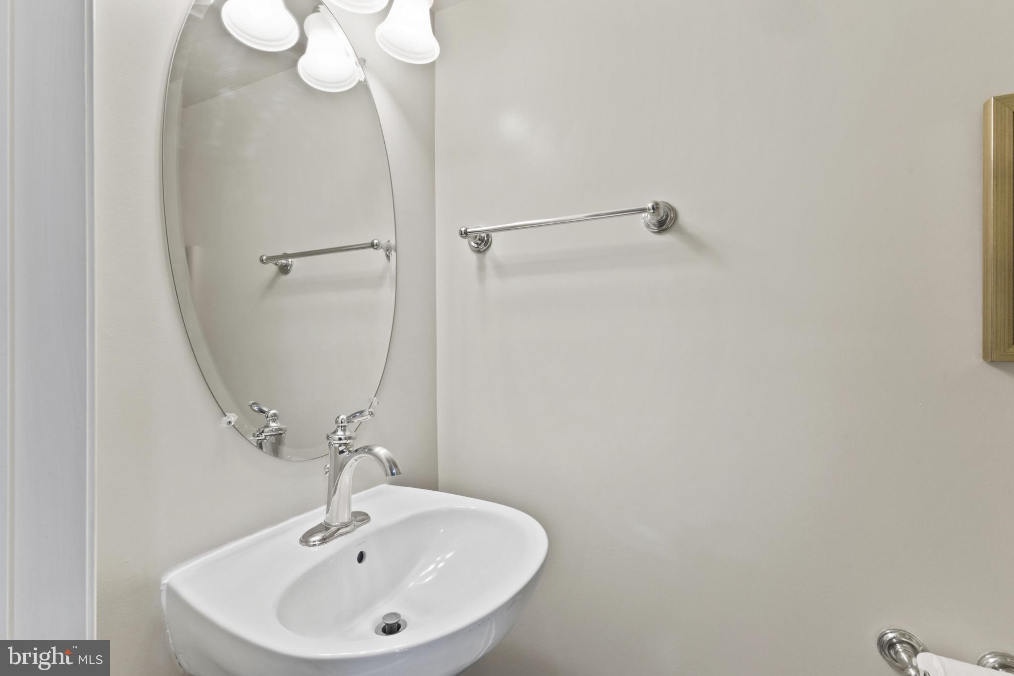 573 Dandelion Terrace Southeast Leesburg, VA 20175 - Photo 14 of 31 a bathroom with a sink a mirror and a shower
