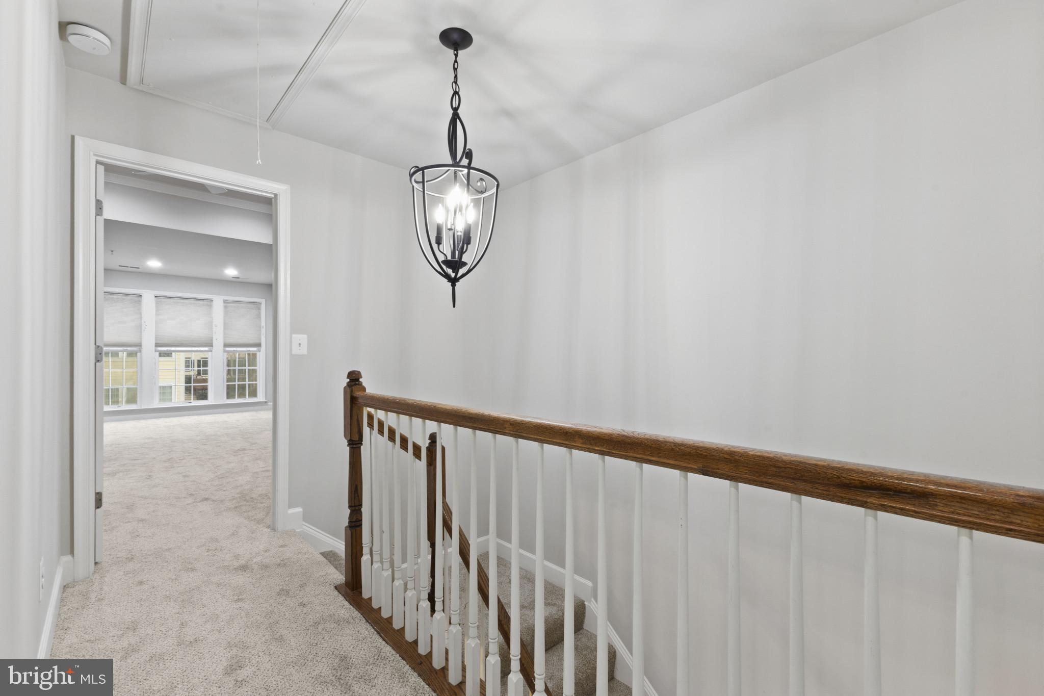 573 Dandelion Terrace Southeast Leesburg, VA 20175 - Photo 15 of 31 a view of a hallway with a chandelier