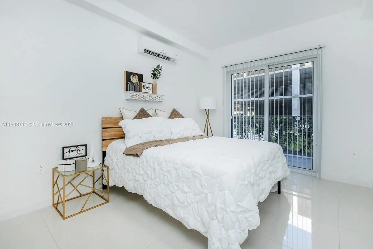 25850 Southwest 140th Court, Unit 6209 Homestead, FL 33032 - Photo 11 of 29 a bedroom with a bed and a window