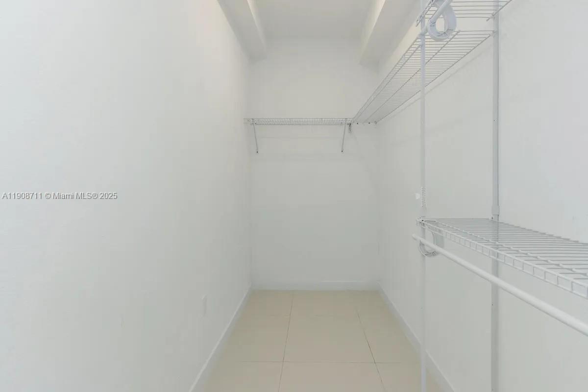 25850 Southwest 140th Court, Unit 6209 Homestead, FL 33032 - Photo 12 of 29 a view of storage and utility room with empty racks