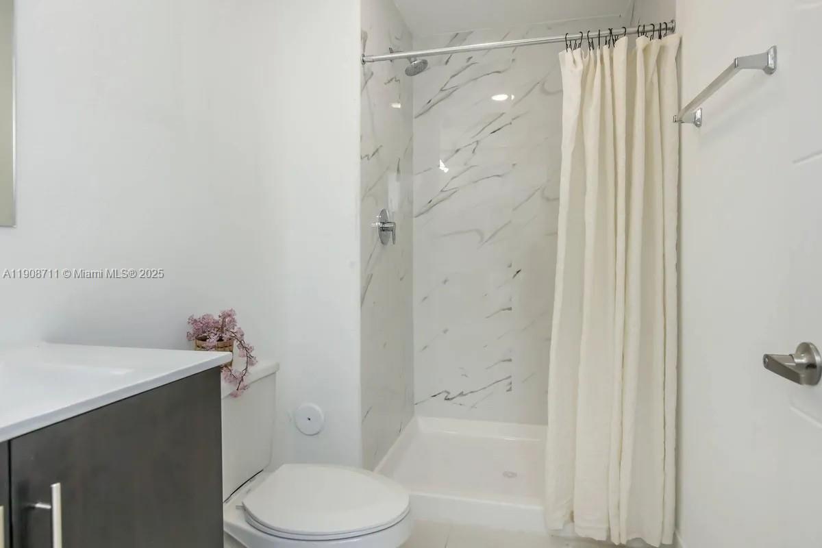 25850 Southwest 140th Court, Unit 6209 Homestead, FL 33032 - Photo 14 of 29 a bathroom with a sink a toilet and shower