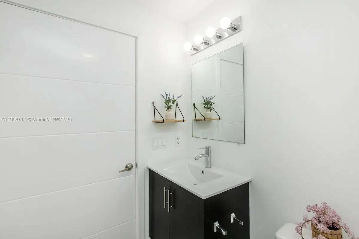 25850 Southwest 140th Court, Unit 6209 Homestead, FL 33032 - Photo 15 of 29 a bathroom with a sink and mirror