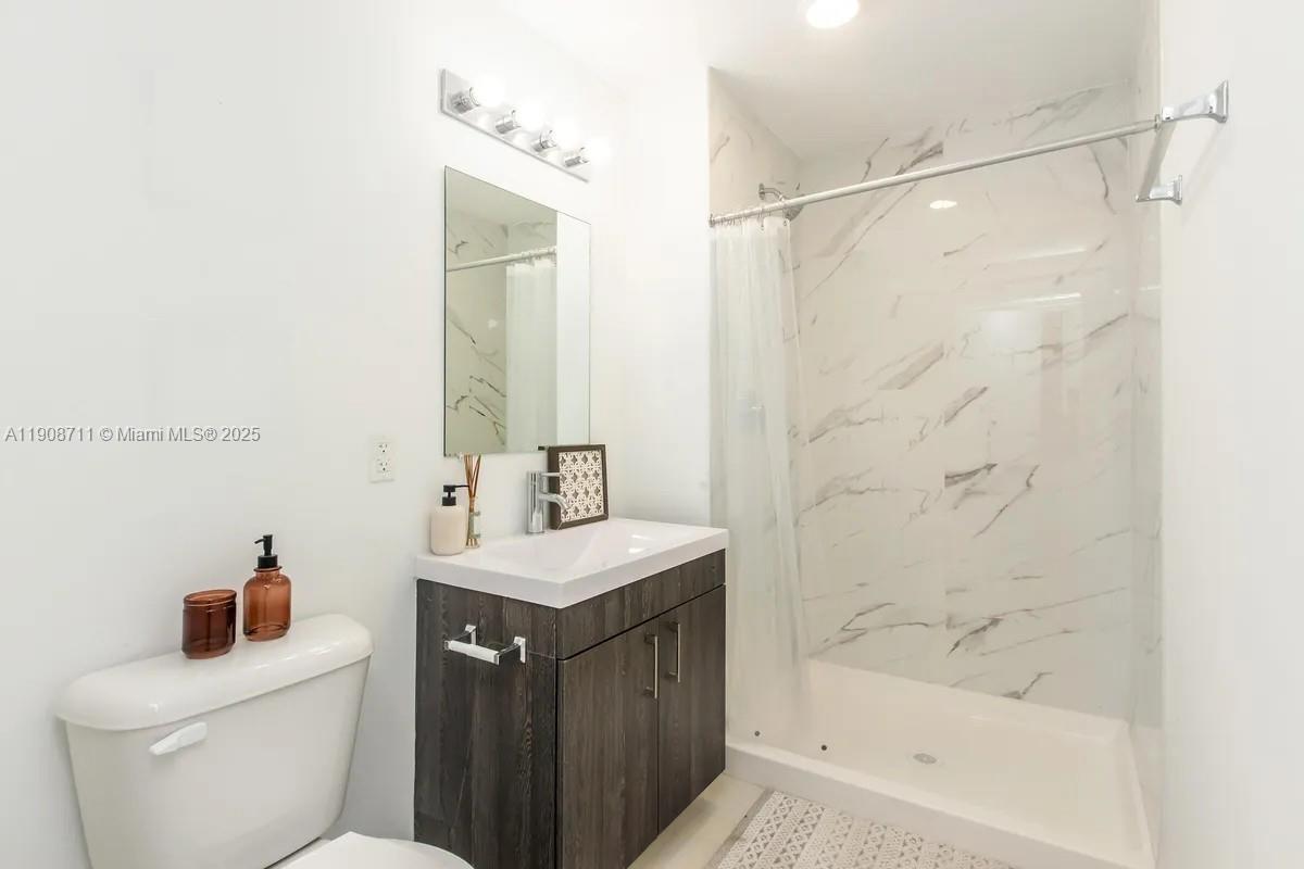 25850 Southwest 140th Court, Unit 6209 Homestead, FL 33032 - Photo 16 of 29 a bathroom with a sink a toilet and shower