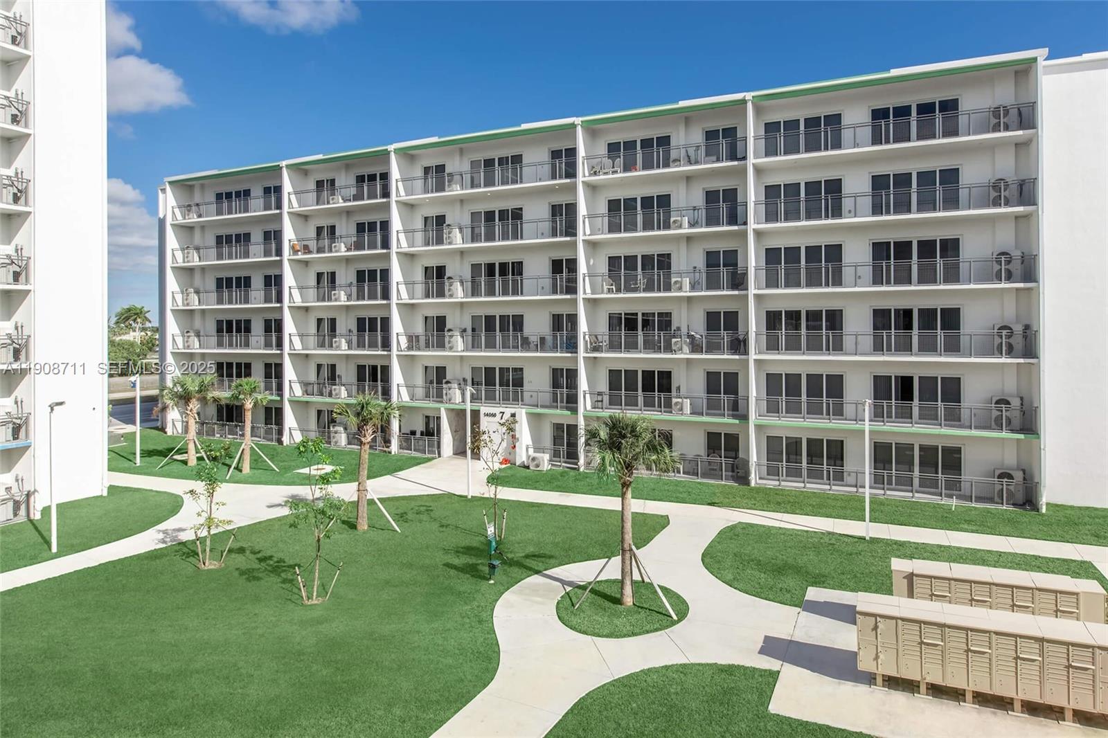 25850 Southwest 140th Court, Unit 6209 Homestead, FL 33032 - Photo 20 of 29 a front view of a building with a garden