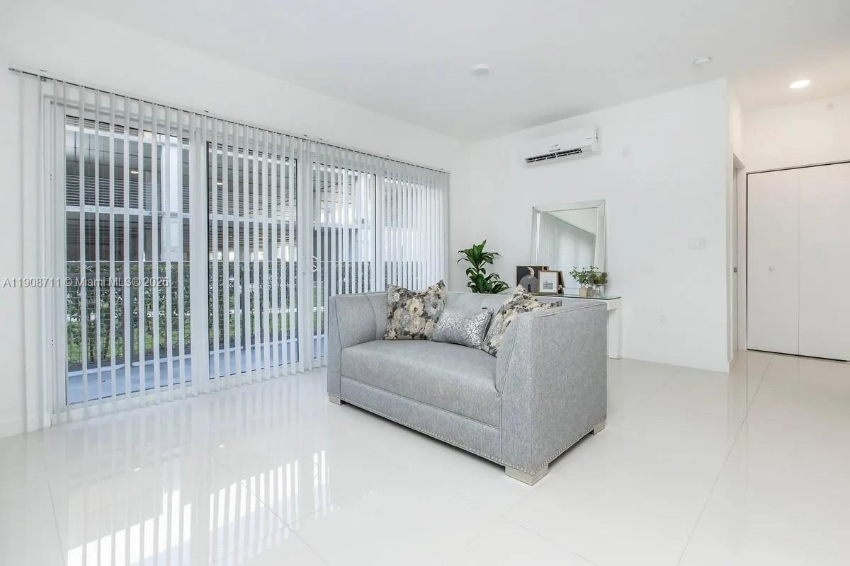 25850 Southwest 140th Court, Unit 6209 Homestead, FL 33032 - Photo 3 of 29 a living room with furniture and a window