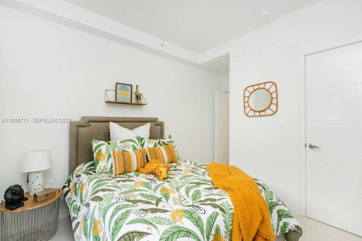25850 Southwest 140th Court, Unit 6209 Homestead, FL 33032 - Photo 8 of 29 a bedroom with a bed and painting on the wall