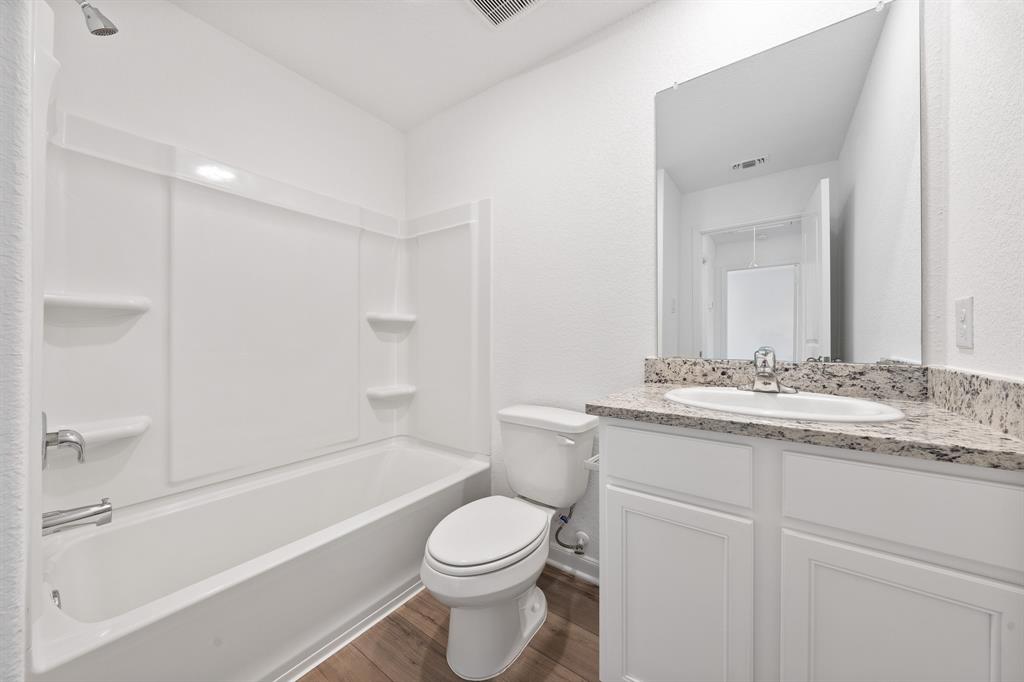585 Aplite Pass Maxwell, TX 78656 - Photo 13 of 13 a bathroom with a granite countertop sink toilet and shower