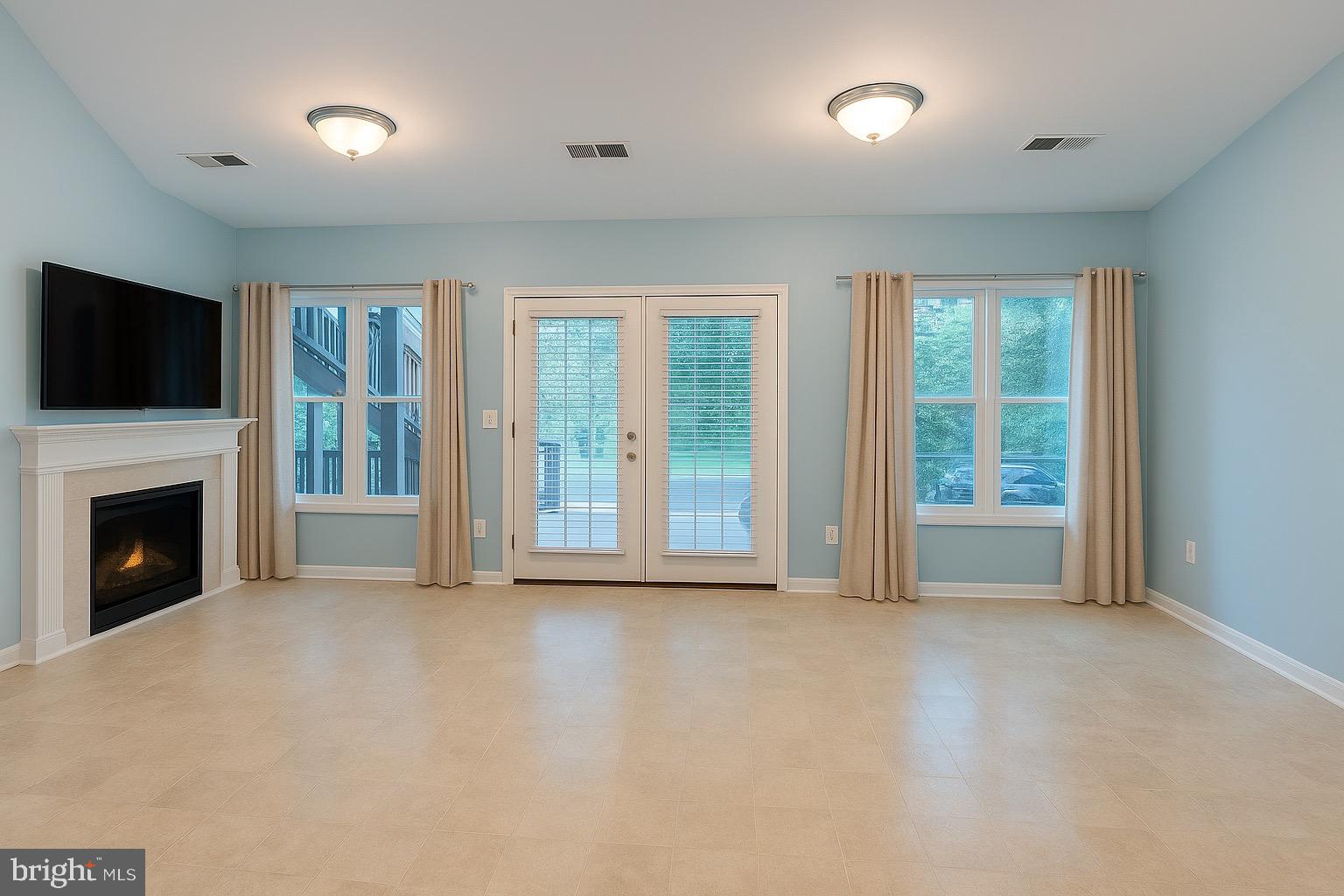 305 Wakefield Drive Locust Grove, VA 22508 - Photo 4 of 54 a view of an empty room with a fireplace and a window
