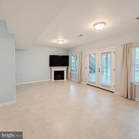an empty room with a fireplace and a window