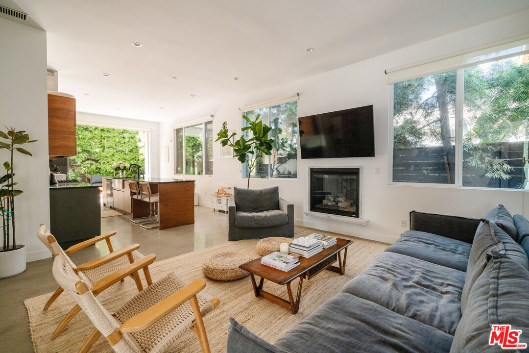 2437 Walnut Avenue Venice, CA 90291 - Photo 11 of 44 a living room with furniture a flat screen tv and a fireplace