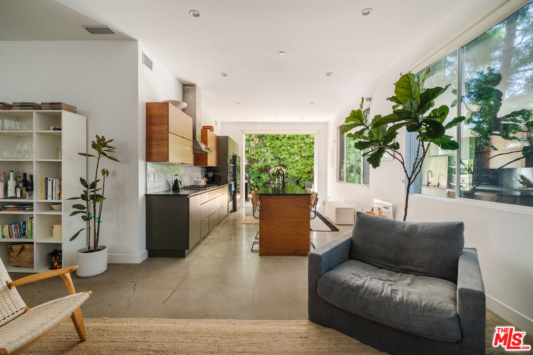 2437 Walnut Avenue Venice, CA 90291 - Photo 12 of 44 a living room with furniture potted plant and a large window