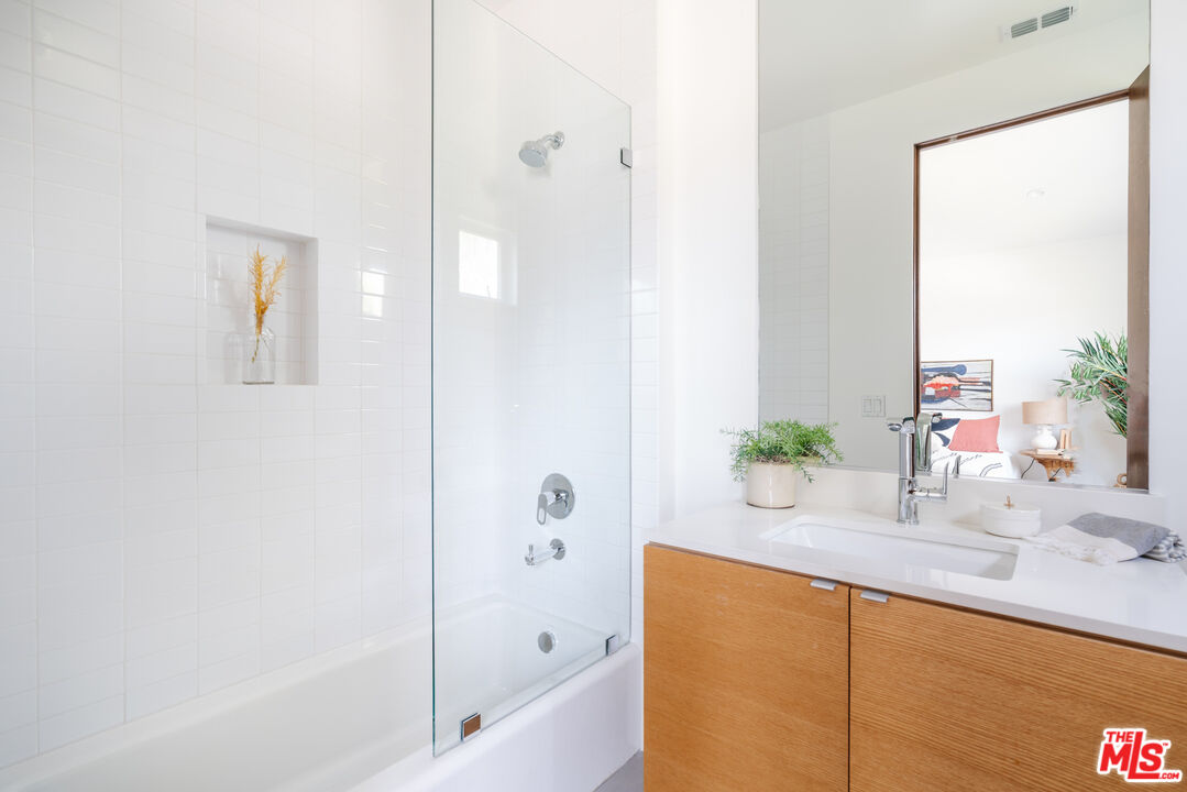 2437 Walnut Avenue Venice, CA 90291 - Photo 29 of 44 a bathroom with a granite countertop sink and a mirror