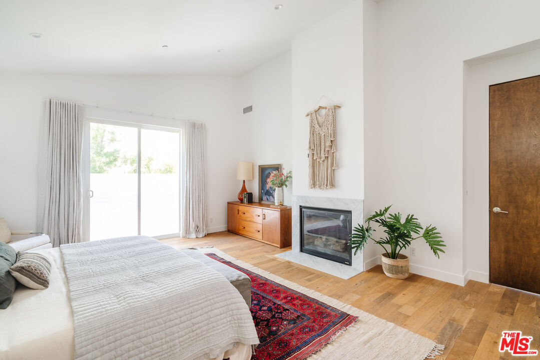 2437 Walnut Avenue Venice, CA 90291 - Photo 32 of 44 a bedroom with a large bed a couch and a window