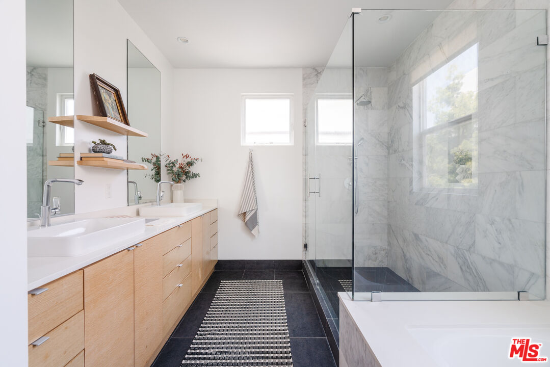 2437 Walnut Avenue Venice, CA 90291 - Photo 35 of 44 a bathroom with a granite countertop sink a toilet and shower