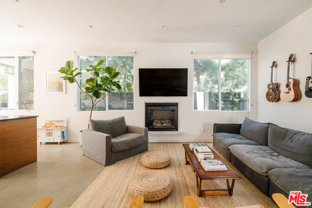2437 Walnut Avenue Venice, CA 90291 - Photo 10 of 44 a living room with furniture a flat screen tv and a fireplace